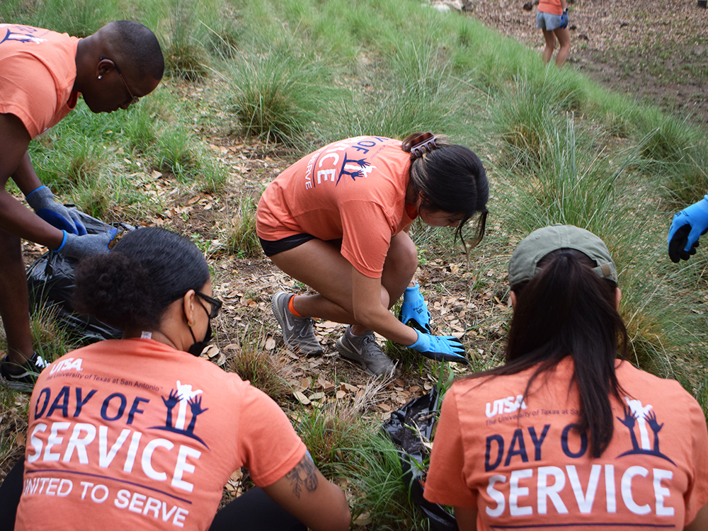 Students pulling weeds together at Day of Service
