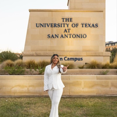 Sophia Kayani posed in front of the UT San Antonio main campus front sign.