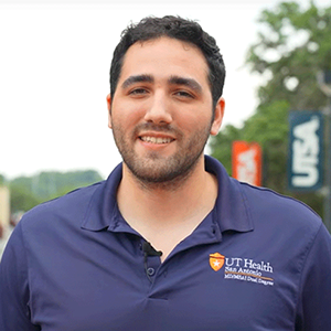 Aaron Fanous UTSA alumni posing on campus after earning MD/MSAI degree