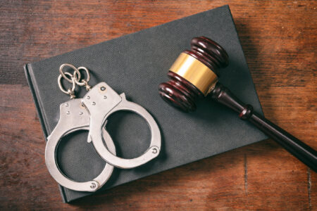 a book, gavel, and set of handcuffs