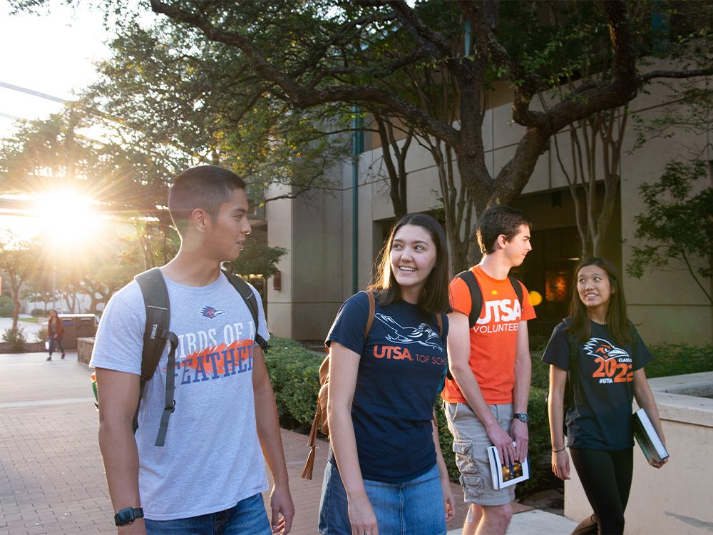 students talking while walking on campus at The University of Texas at San Antonio