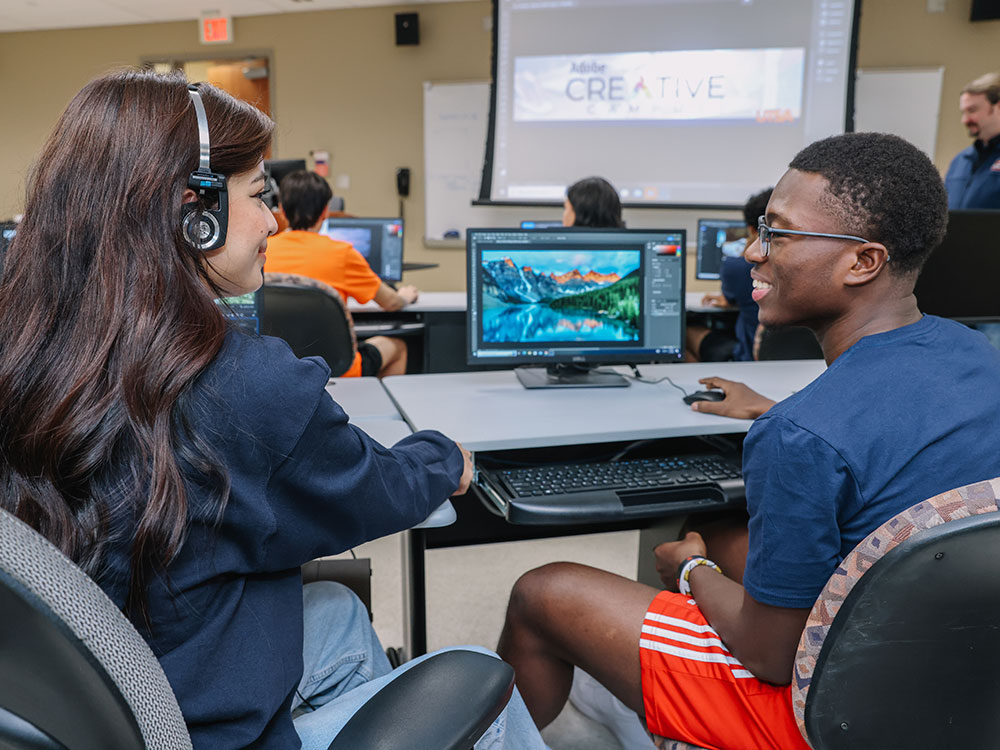 Two UTSA students working together using Adobe Creative Cloud software.