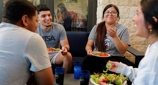 A group of students sharing a UT San Antonio dining meal