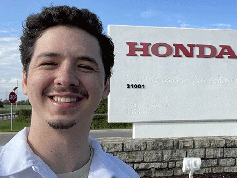 Eduardo Garcia in front of Honda sign.