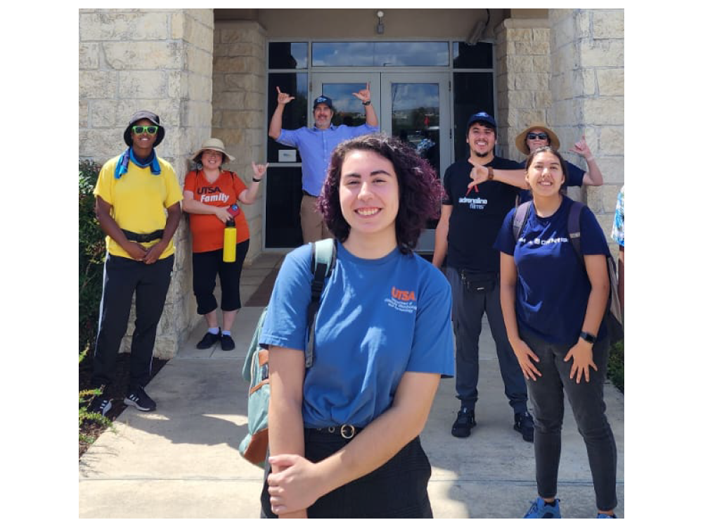 Emily Perez with their peers outside a UT San Antonio campus lab.