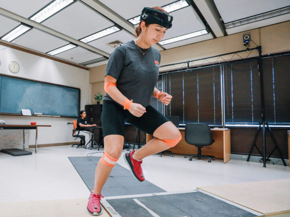 Student in classroom doing physical exercises.