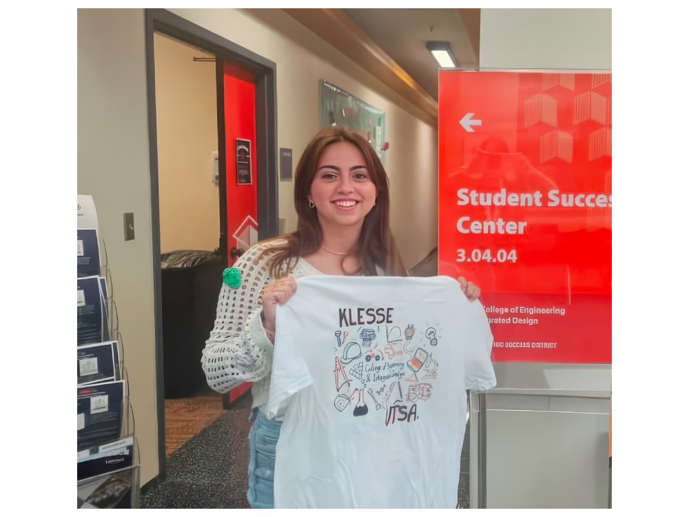 Kaylee Bostic with her winning submission for the Klesse College T Shirt Design contest