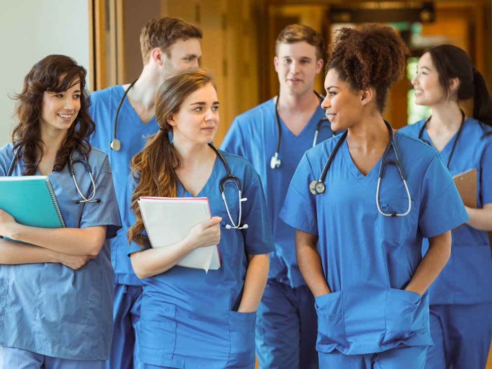 pre-medicine students in scrubs in medical setting