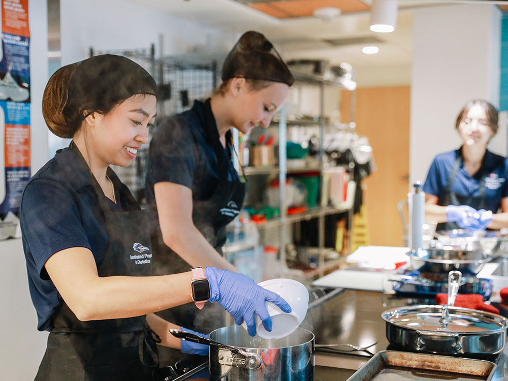 nutrition and dietetics students work in a kitchen at utsa