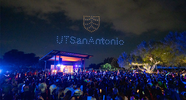 Drones displaying the UT San Antonio logo in the night sky during Rowdy Glow