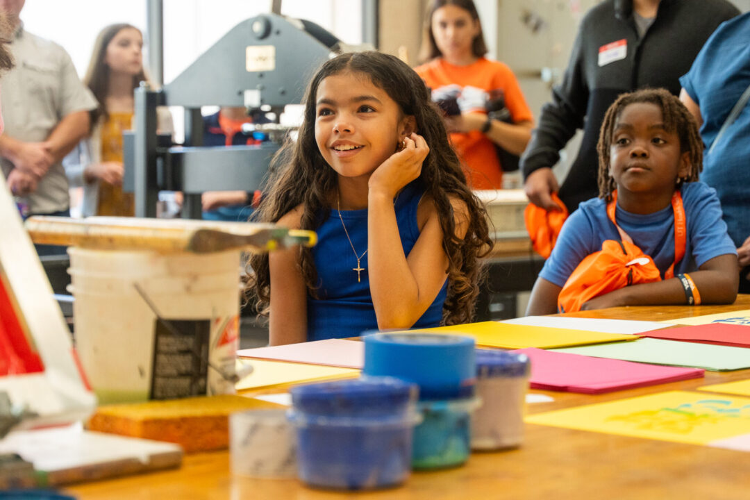 Elementary-aged children paying attention in a classroom.