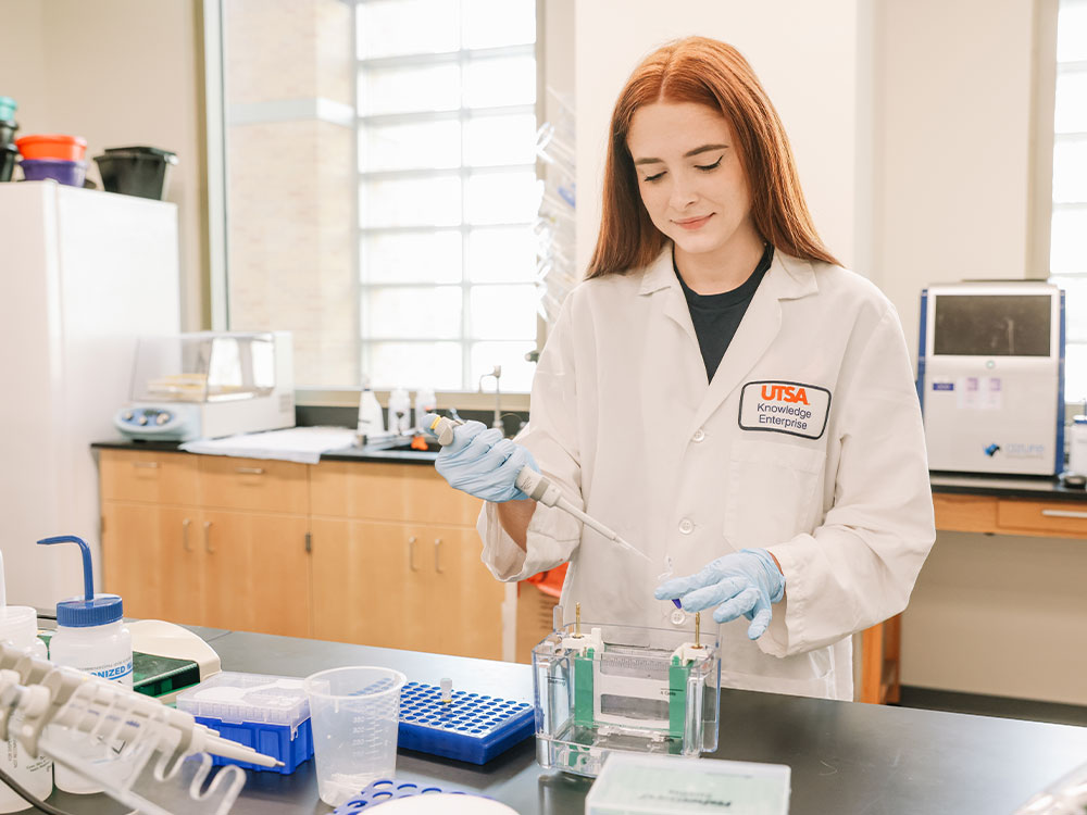 chemistry student works in lab with pipette