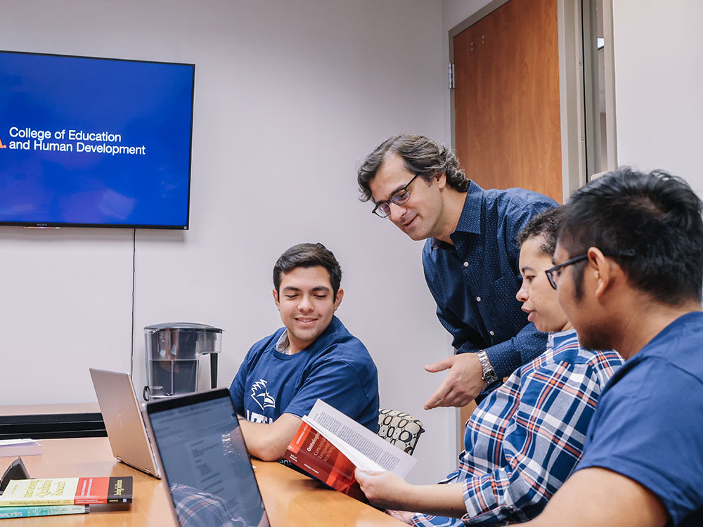 Professor and students working together.
