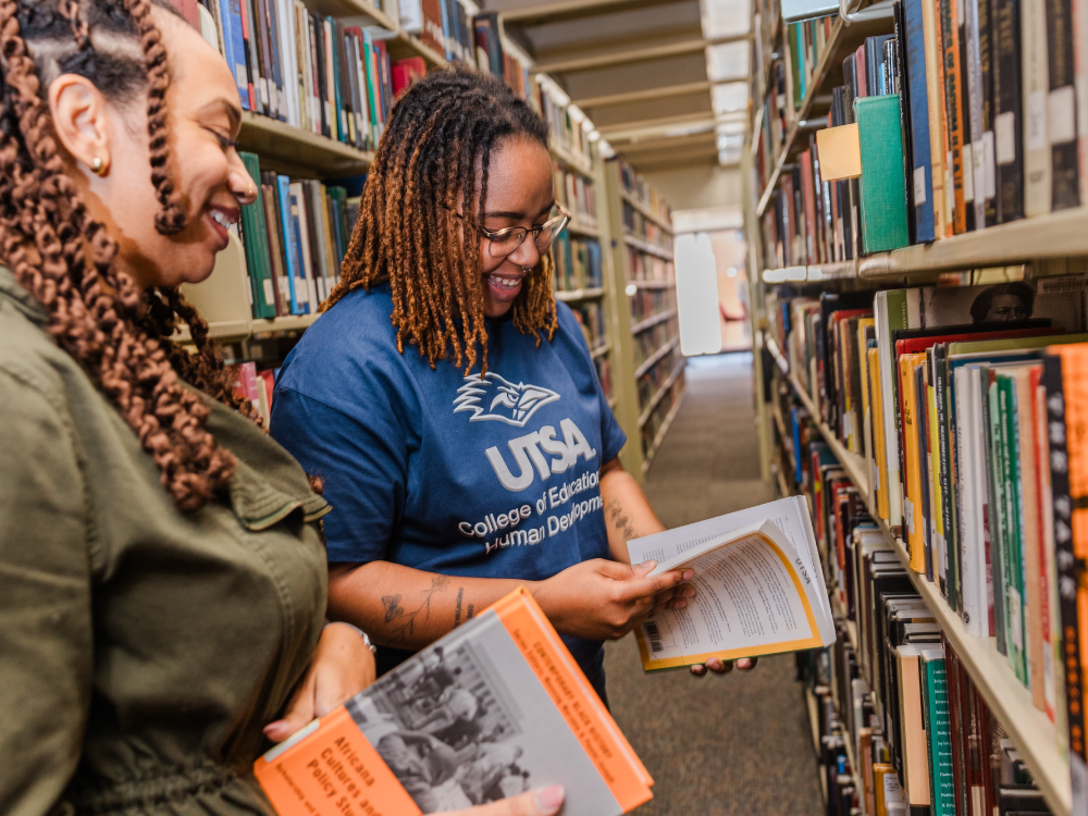 Students from the College of Education and Human Development reading books.