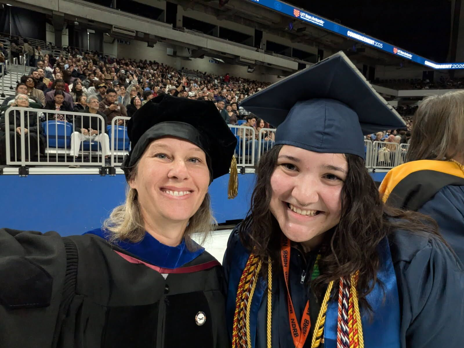 Emily Holder at UT San Antonio Commencement with Dr Lindsey Macpherson.