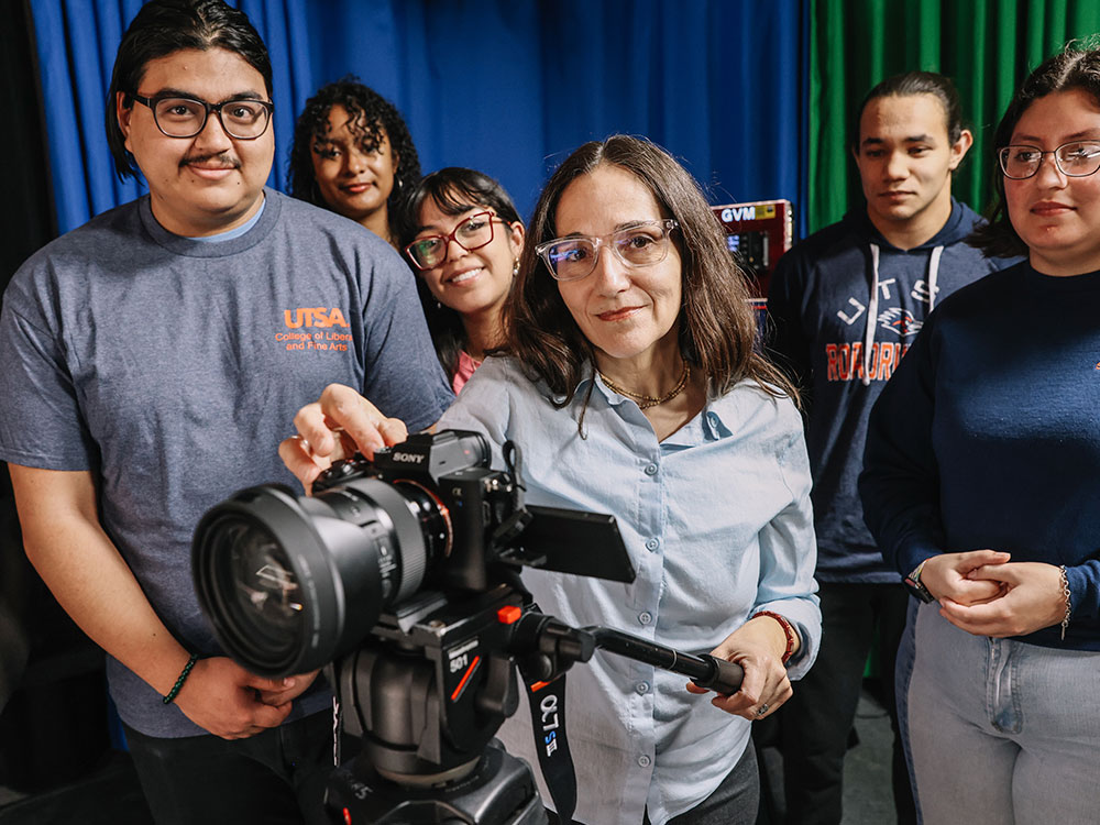 Film and Media students and faculty gathered around a professional camera.