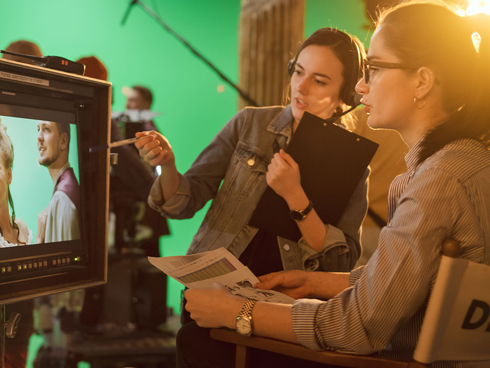 Two directors reviewing footage on set.