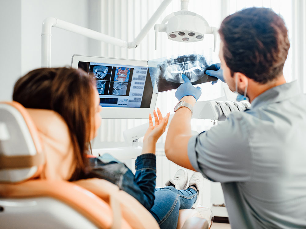 Dentist reviewing X-rays with a patient.