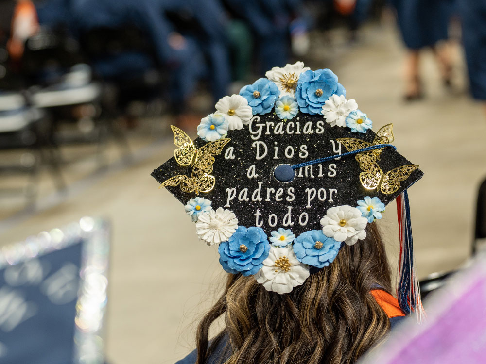 UTSA graduate showcasing decorated mortarboard