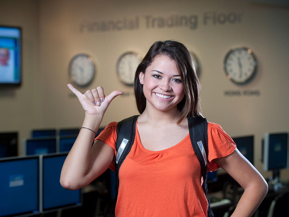 utsa student in college of business with birds up